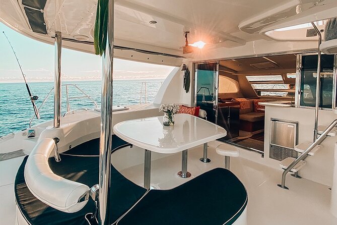 Private Oahu Sunset Charter with Tasting and Drinks - The Sunset Channel stop: foot-dip, anchored views, and slow evening colors